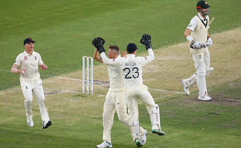 Cricketer James Bracey celebrates with others after a wicket